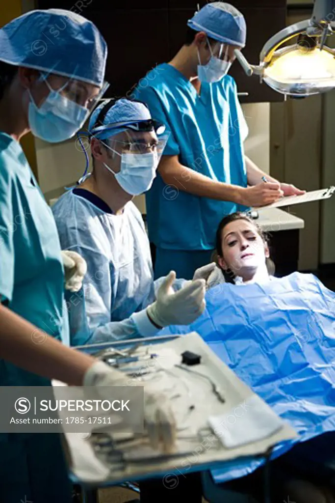Portrait of dentist and assistants working on patient