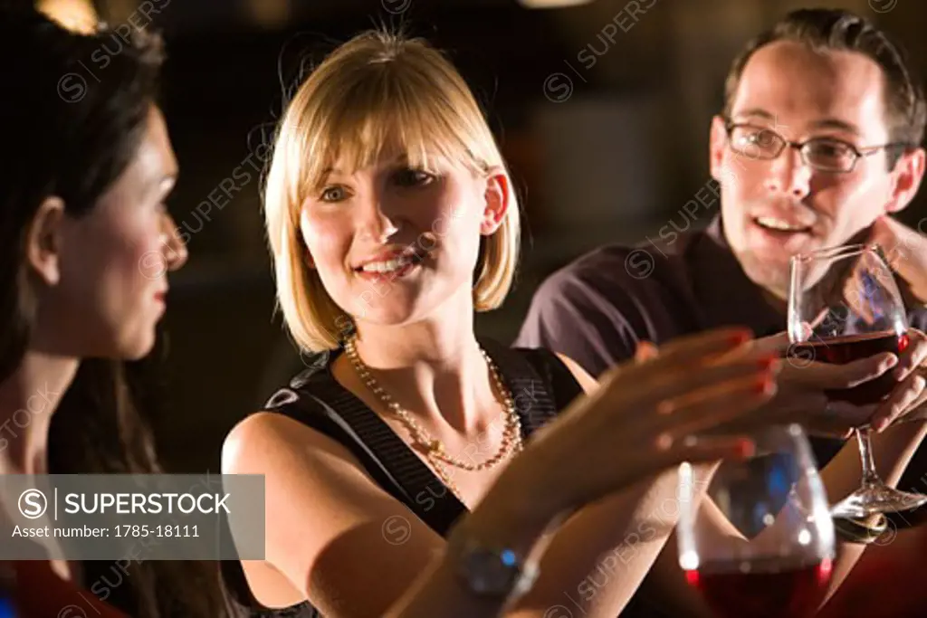 Young adult friends hanging out at restaurant bar