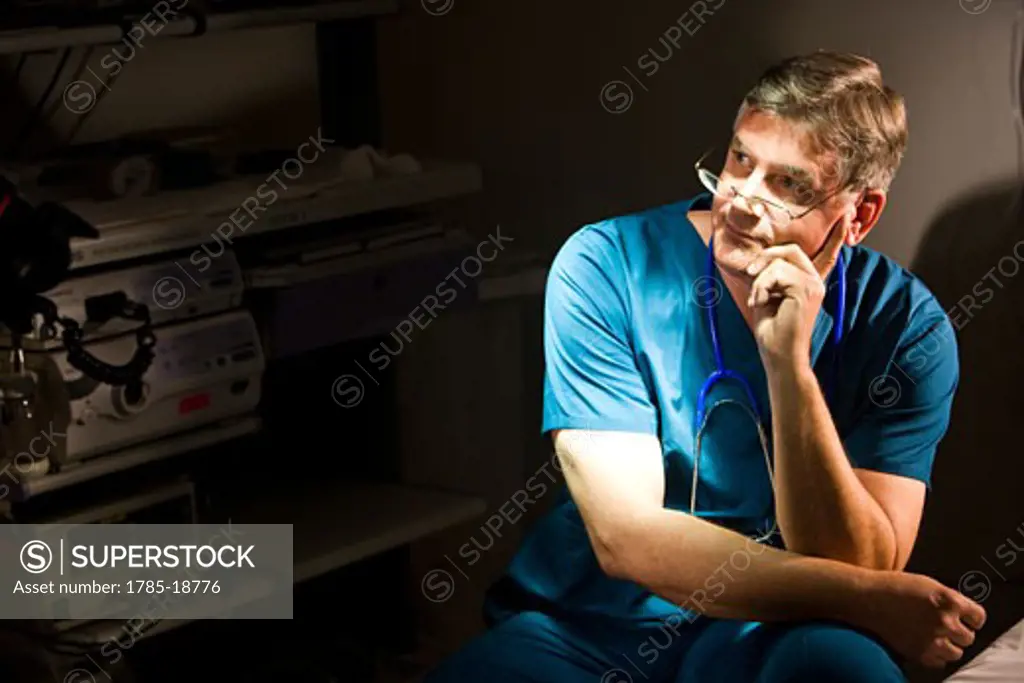 Portrait of middle-aged doctor in scrubs