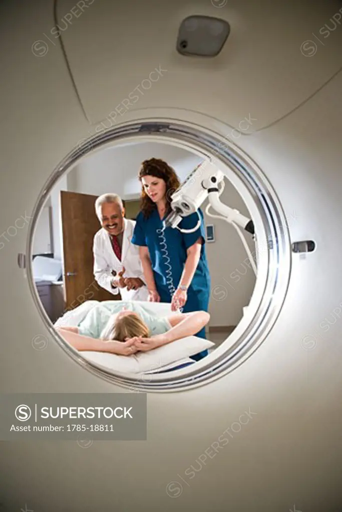 Healthcare workers preparing patient for CAT scan
