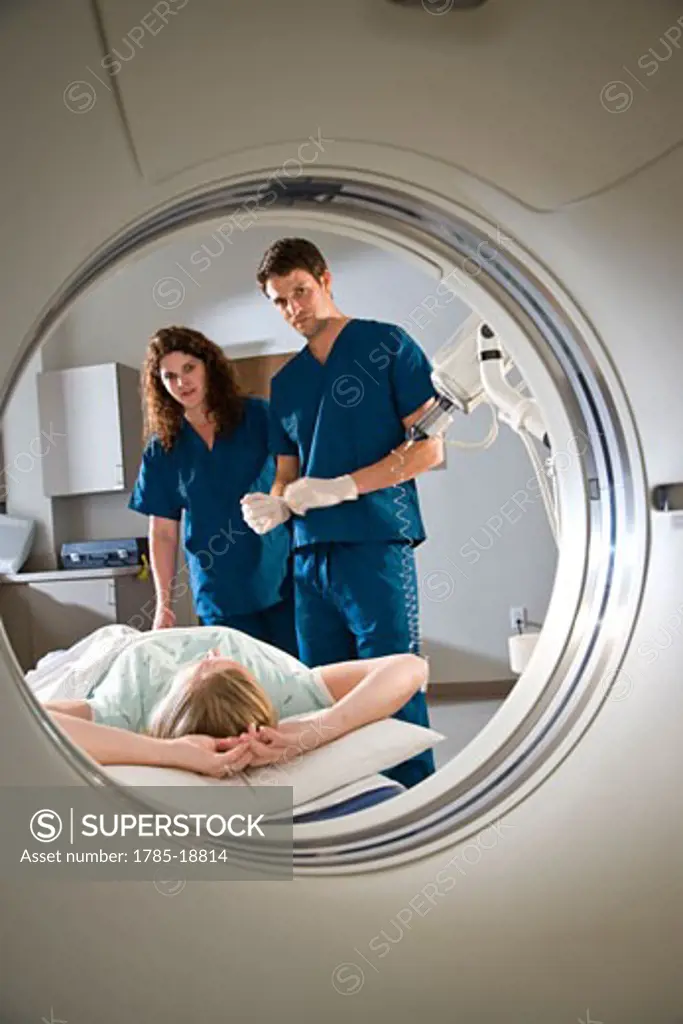 Healthcare workers preparing patient for CAT scan
