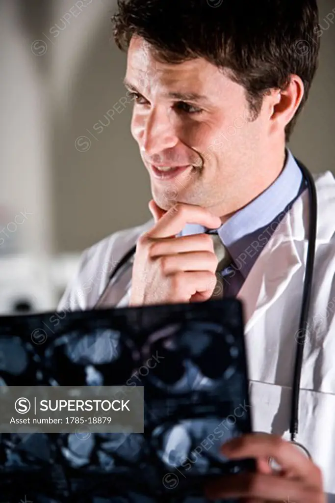 Doctor holding up a CT scan