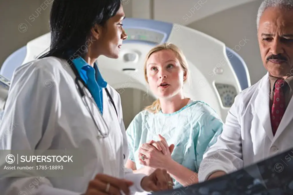 Doctors reviewing CT scan results with patient