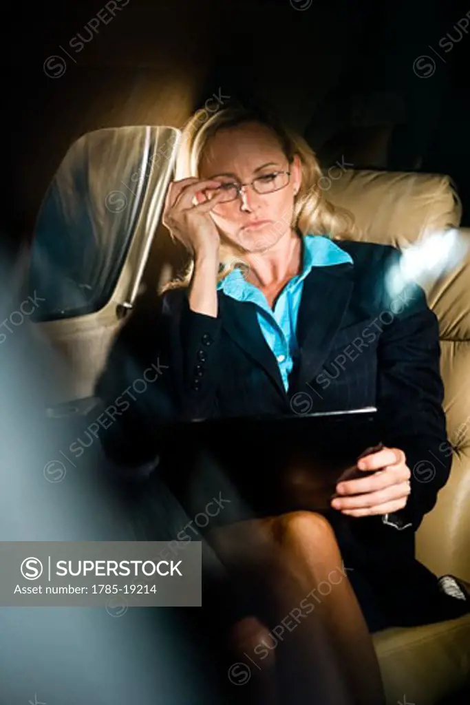 Businesswoman traveling in corporate jet