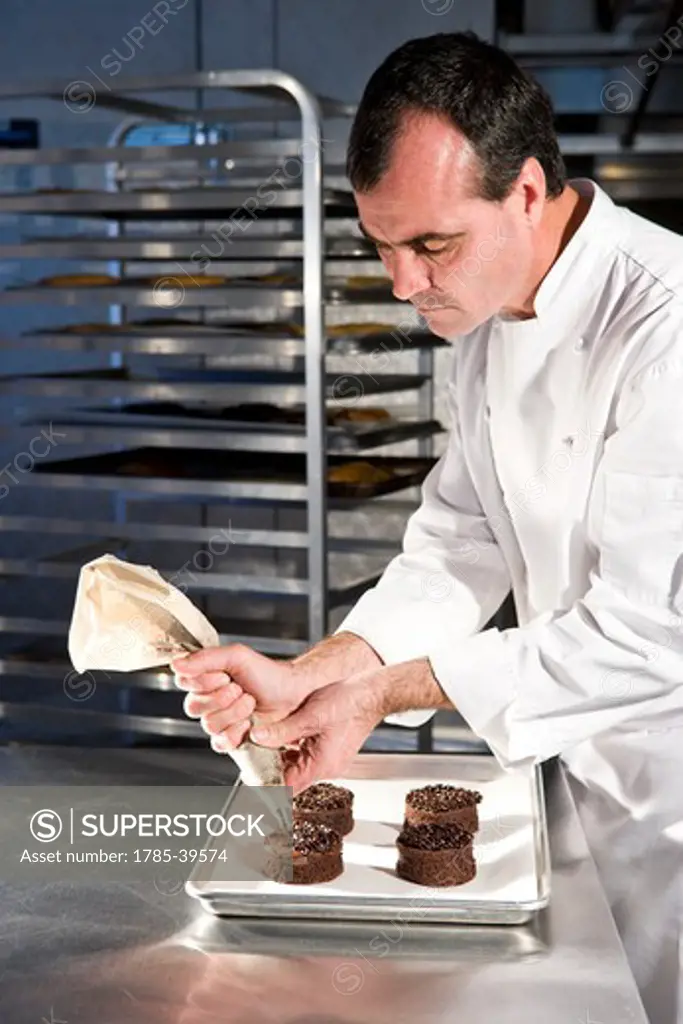 Pastry chef decorating chocolate dessert pastries