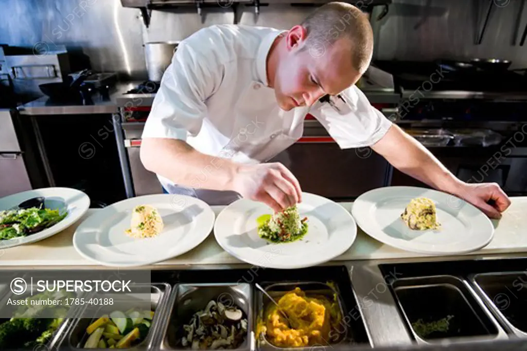 Chef in restaurant kitchen preparing gourmet dishes