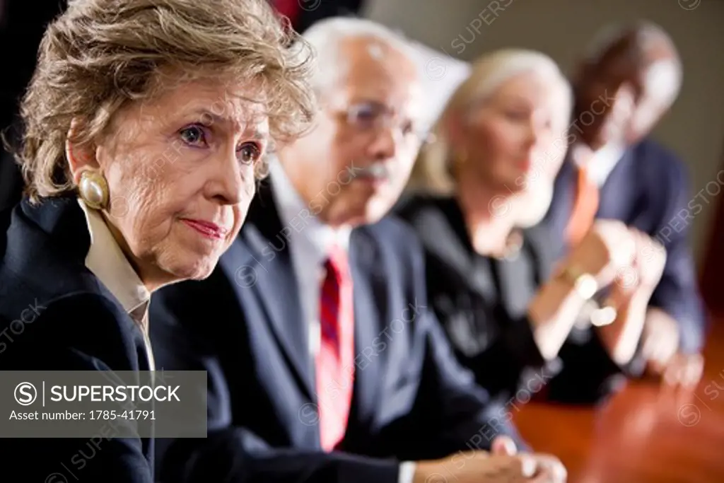 Woman watching in multi-ethnic senior management meeting