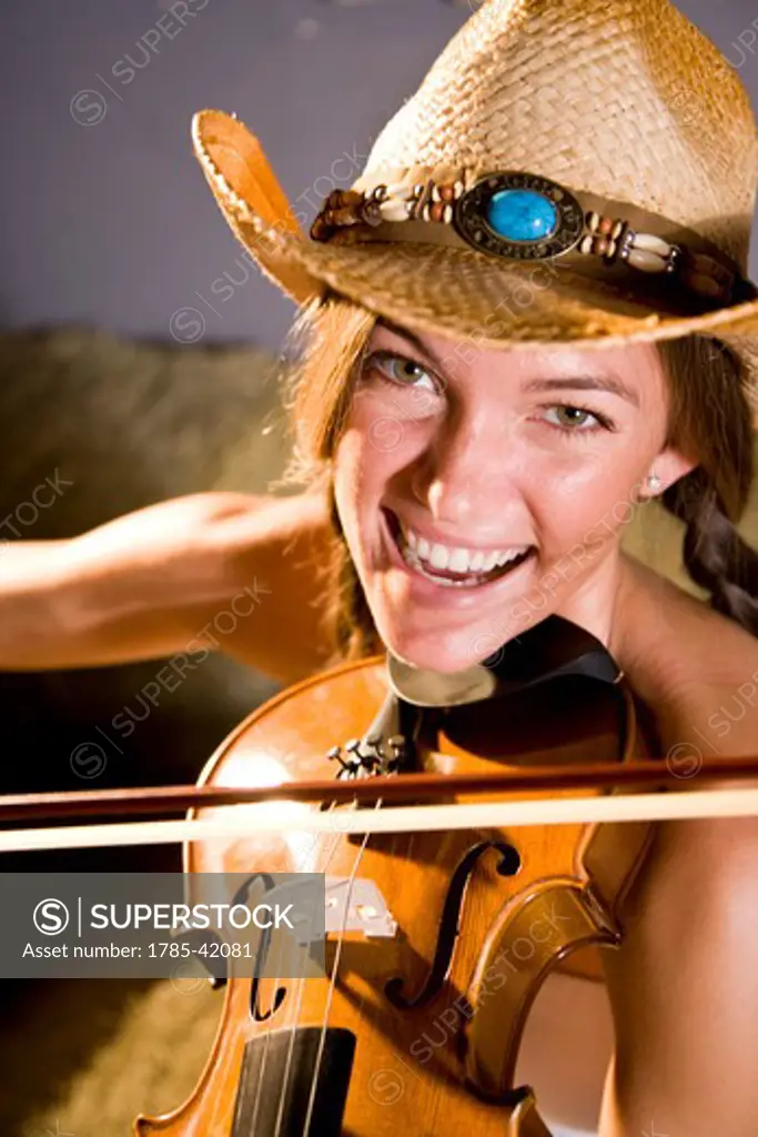 Face of country girl playing fiddle