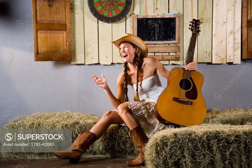 Laughing country western girl with guitar