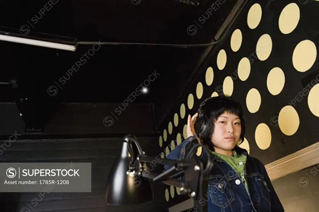 Portrait of a young Asian woman listening to music