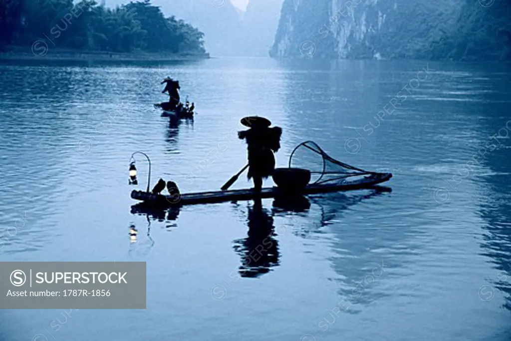 Silhouette of people fishing on Li River, Yangshuo County, Guilin City, Guangxi Zhuang Nationality Autonomous Region of People's Republic of China,