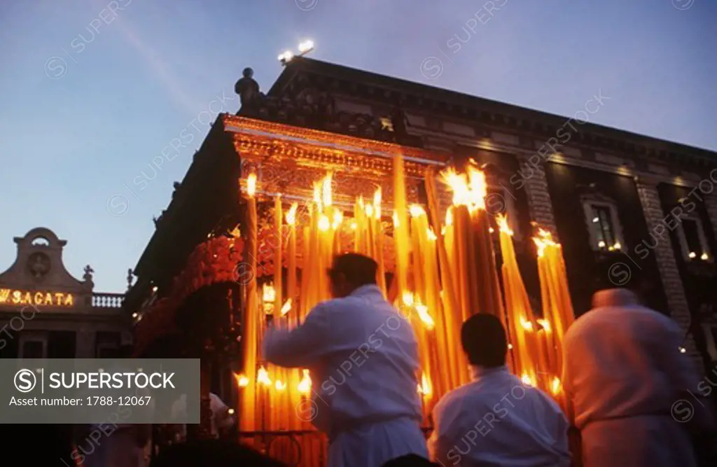 Italy, Sicily region, Festival of Saint Agatha, devotees light candles on the ""Fercolo""