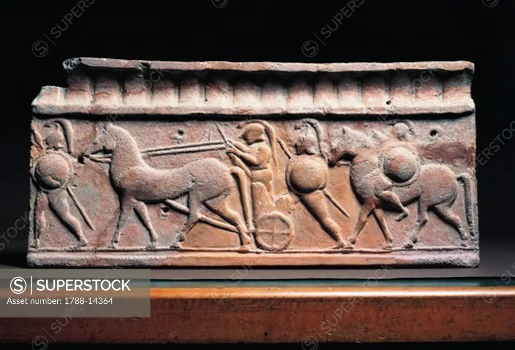 Clay slab depicting a warrior in typical Greek amour getting on a chariot from Arce di Veio Temple