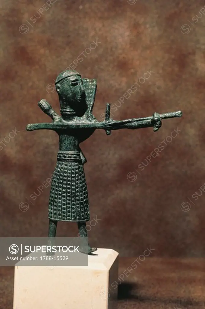 Bronze statue depicting an archer shooting in an oriental style short skirt, from Saint Anastasio in Sardara, Sardinia Region, Italy.