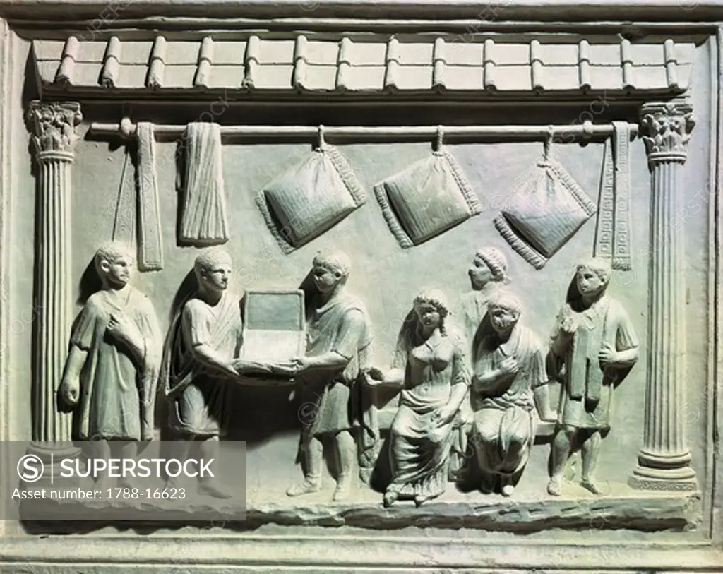 Relief depicting interior of belt and cushion shop, with owner and clerks showing goods to seated buyers and slaves