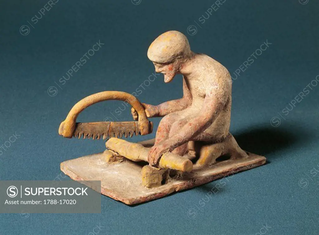 Greek fictile figurine of carpenter at work, from Boeotia, Greece, 5th Century B.C.