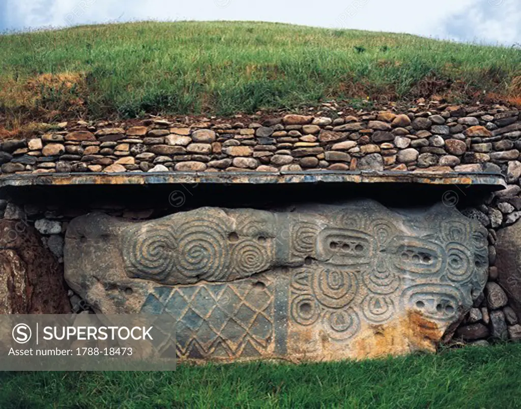 Ireland, County Meath, Newgrange, Northwest side of megalithic monument with engraved stone