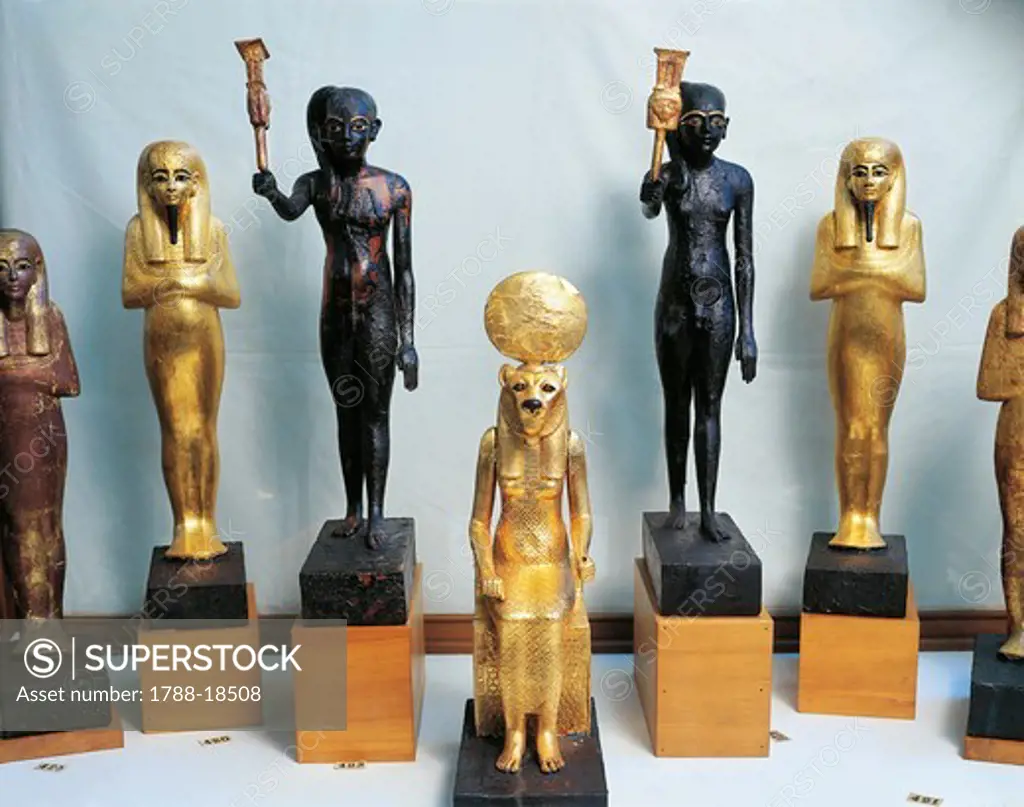 Statuettes of Tutankhamen as god Thy, wood statuettes of sistrum players and gold statuettes of deities, from Valley of the Kings, tomb of Tutankhamen