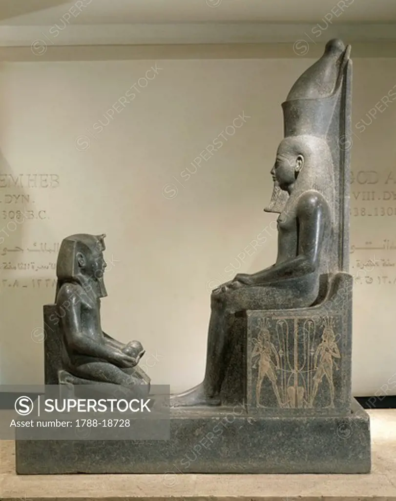 Granite sculptural group portraying Horemheb offering to god Atum