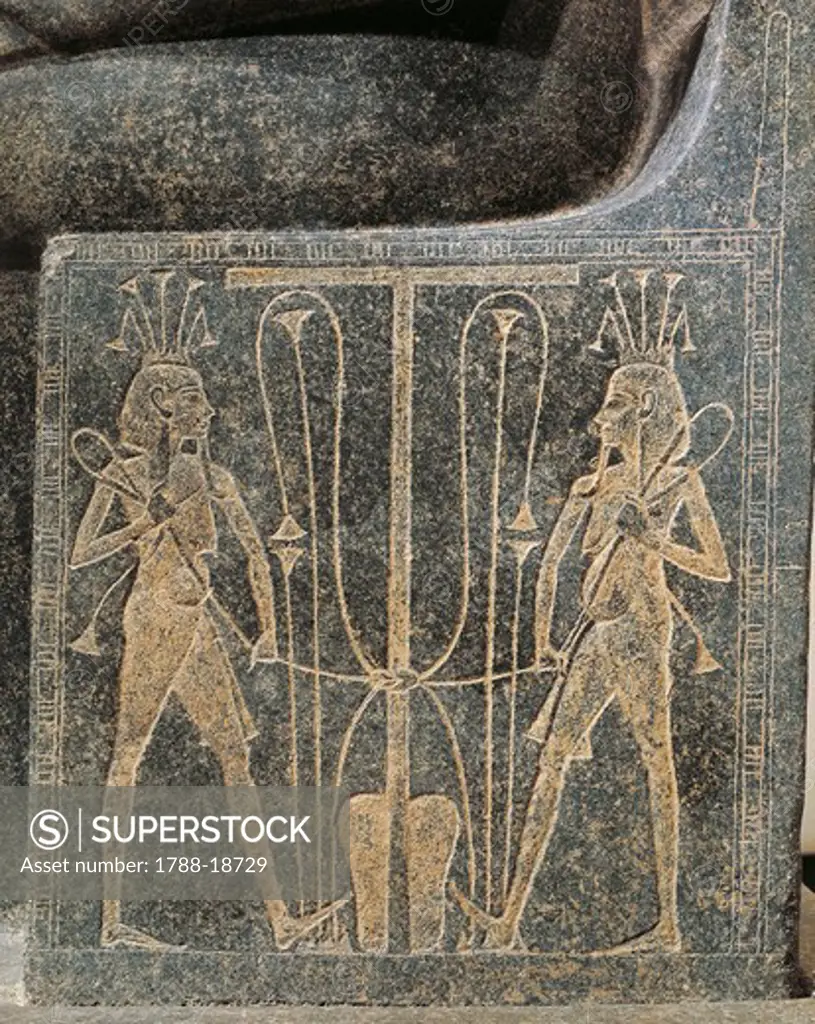 Granite sculptural group with Horemheb making offerings to god Atum, detail of throne of Atum with Seth and Horus