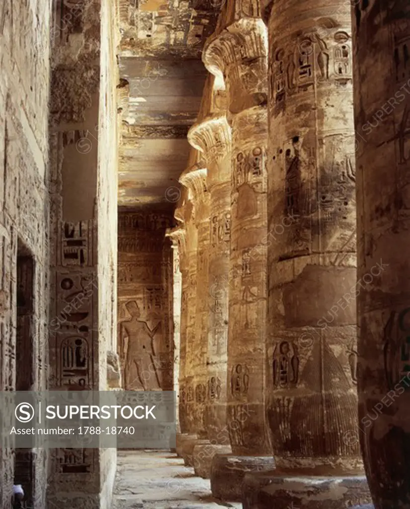 Egypt, Ancient Thebes, Medinet Habu, Temple of Ramses III, first courtyard, south porch, columns with capitals in the form of open papyrus flower and reliefs