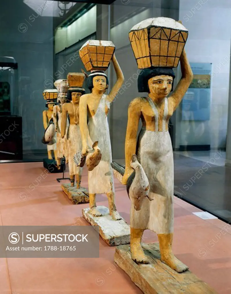 Painted wooden statues representing bearers of offerings