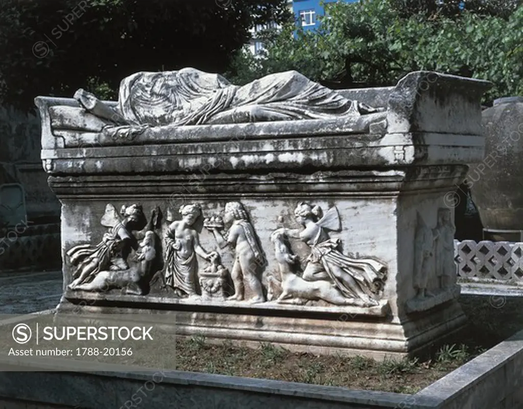 Marble sarcophagus, Statue on lid portraying deceased lying down. Relief along sarcophagus' sides showing sacrifice, from Antioch, Turkey