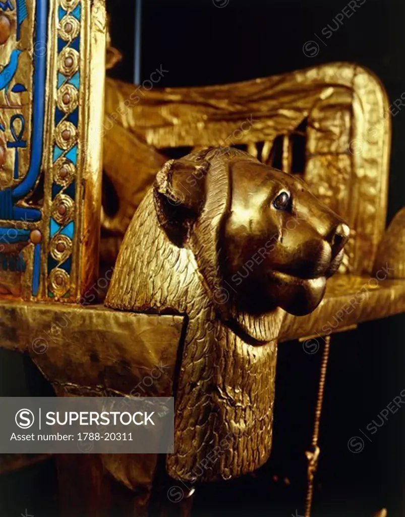 Lion head on front side of throne depicting Tutankhamen and wife Ankhesenamon protected by solar disc, from Treasure of Tutankhamen