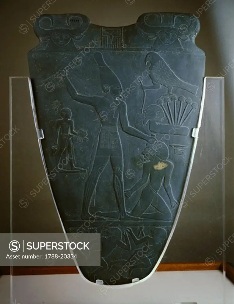 Schist votive Narmer Palette, with relief depicting Pharaoh wearing White crown of Upper Egypt, striking enemy, from Kom el Ahmar