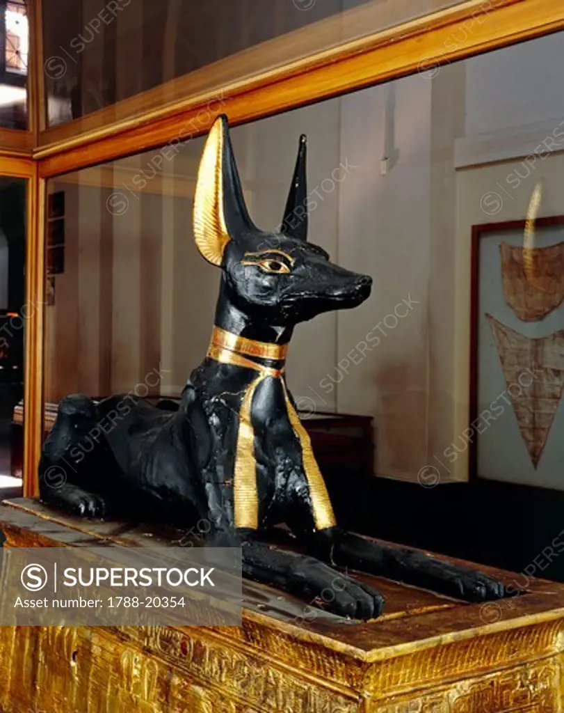 Treasure of Tutankhamen, wooden statue of jackal god Anubis upon a gilded chest from New Kingdom