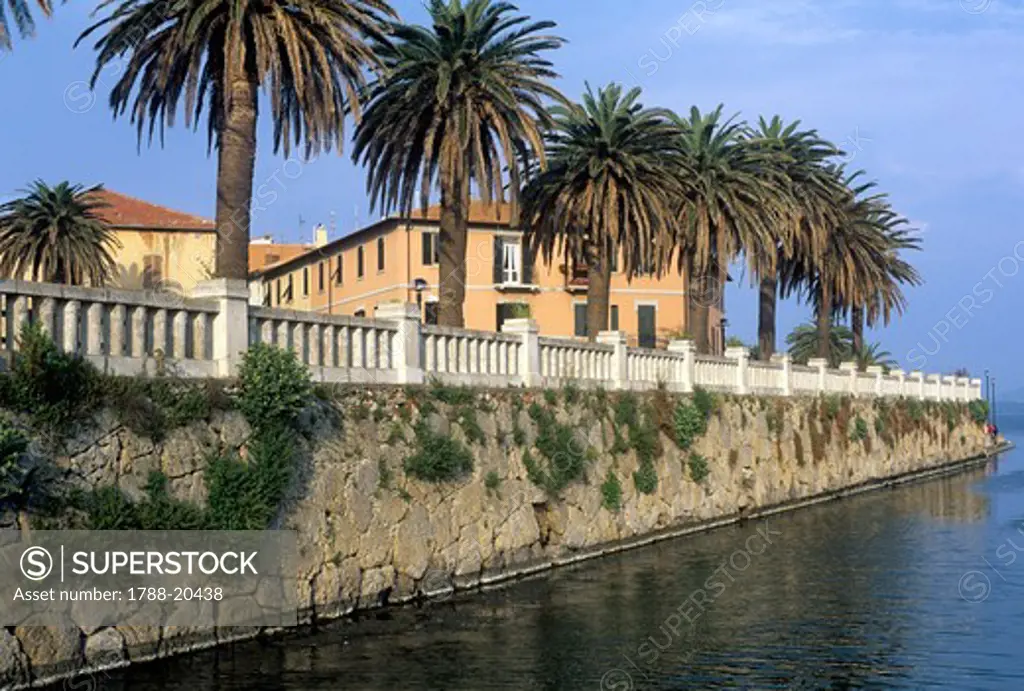 Italy, Tuscany, Maremma, Orbetello, Etruscan wall with palm trees