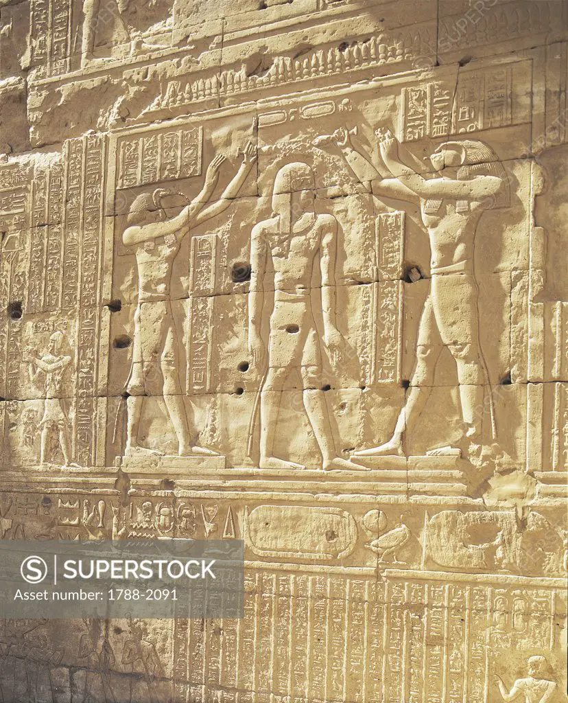 Egypt - Idfu (Edfu). Temple of Horus. Reliefs of pharaoh between gods Horus and Thot. Ptolemaic dynasty