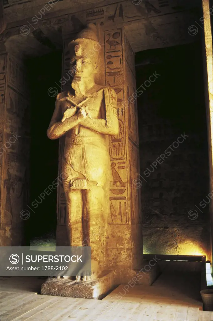 Egypt. Nubian monuments at Abu Simbel (UNESCO World Heritage List, 1979). Great Temple of Ramses II. Hypostyle Hall. Statue of pharaoh depicted as god Osiris