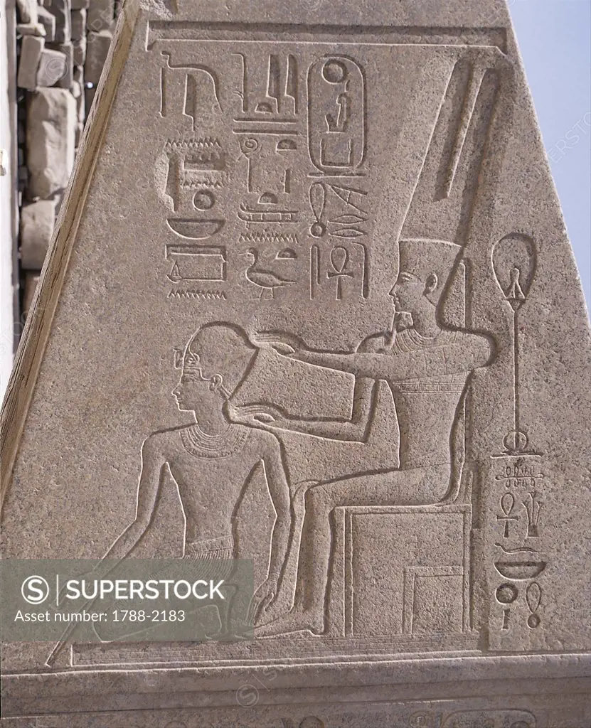 Egypt - Ancient Thebes (UNESCO World Heritage List, 1979). Karnak. Great Temple of Amon. Pink granite obelisk. Relief detail with Queen Hatshepsut protected by Amon