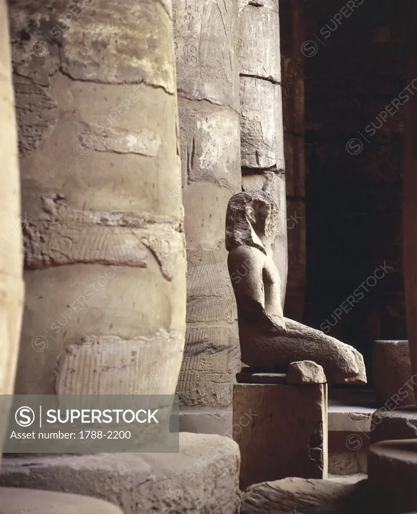 Egypt - Ancient Thebes (UNESCO World Heritage List, 1979). Karnak. Temple of Khons. Eight-pillared hypostyle hall. Detail with statue of son of Amon and Mut moon god Khons