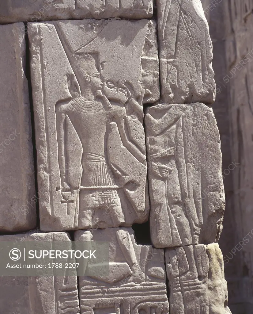 Egypt - Ancient Thebes (UNESCO World Heritage List, 1979). Luxor. Karnak. Great Temple of Amon. Hypostyle hall. Outer walls east. Relief of god Amon offering life-symbol ankh to dead pharaoh