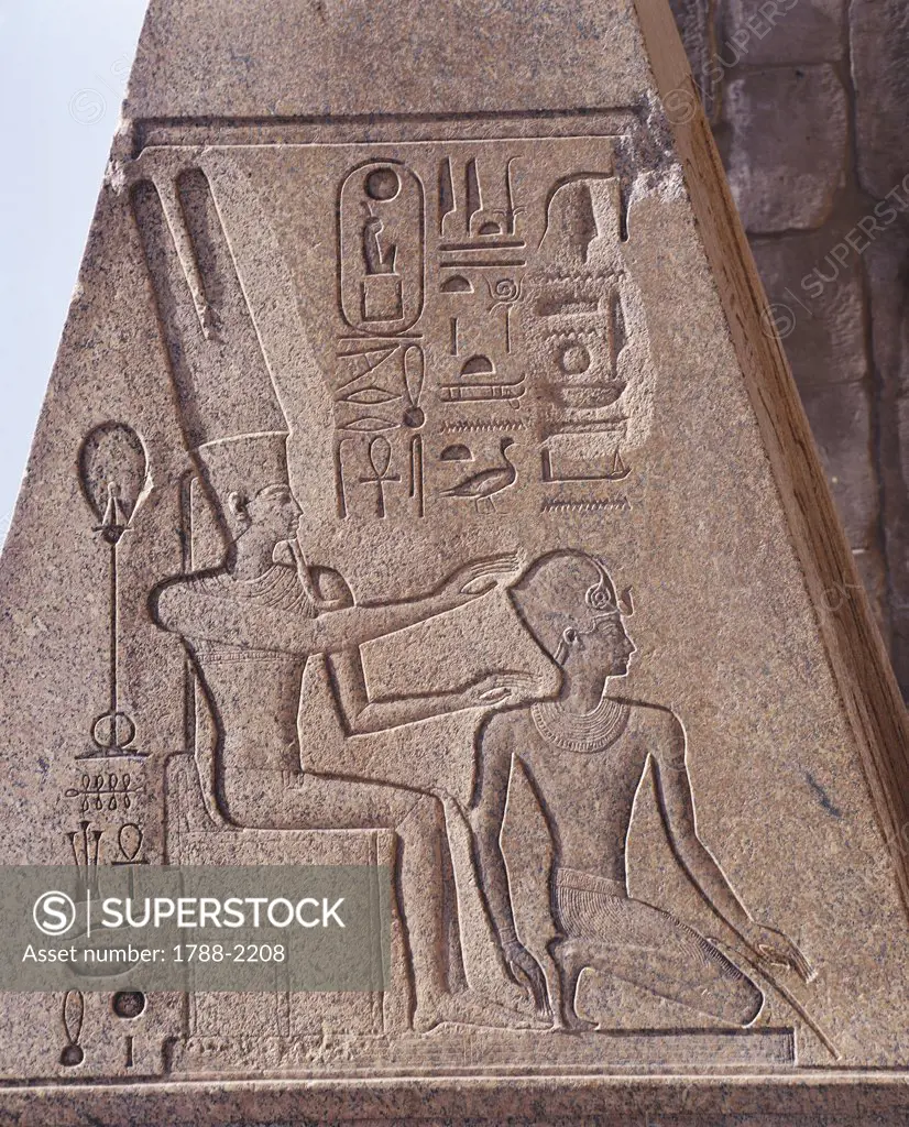 Egypt - Ancient Thebes (UNESCO World Heritage List, 1979). Luxor. Karnak. Great Temple of Amon. Pink granite obelisk. Relief of Amon protecting Hatshepsut as pharaoh
