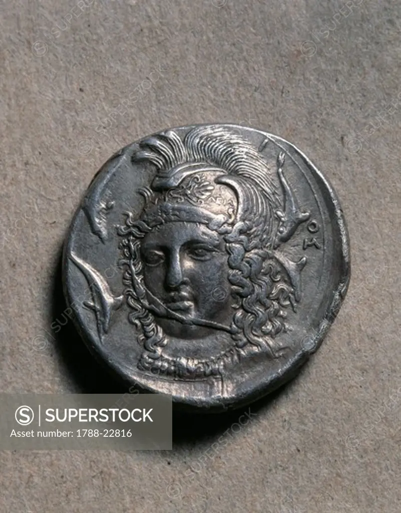 Tetradrachm of Syracuse depicting a female head (probably the head of Athena) surrounded by dolphins, signed by Eucleidas