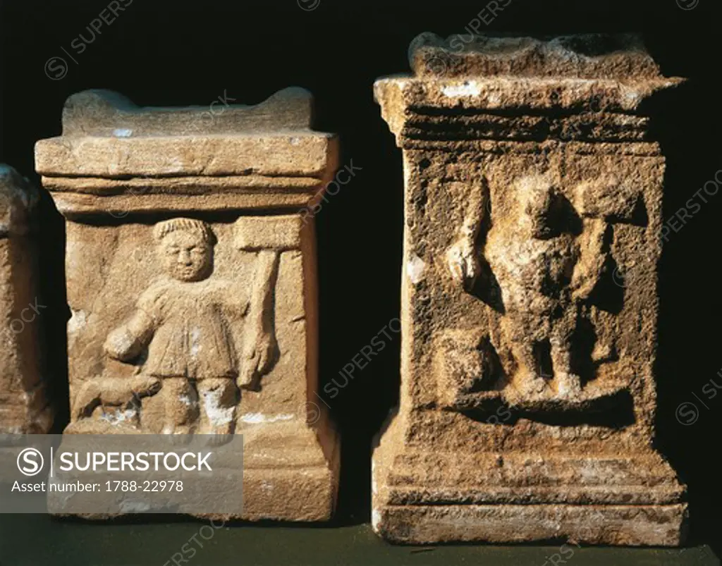 Two small altars with bas-reliefs depicting the Gallic God Sucellus holding an olla in one hand and a wooden mallet in the other