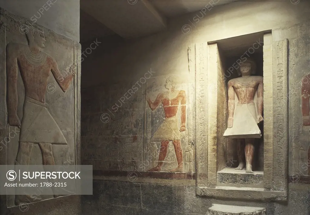 Egypt - Cairo - Ancient Memphis (UNESCO World Heritage List, 1979). Saqqara. Necropolis. Private funerary mastaba of Merekura, 6th Dynasty, 2340 BC. Interior, statue in a niche and painted reliefs.