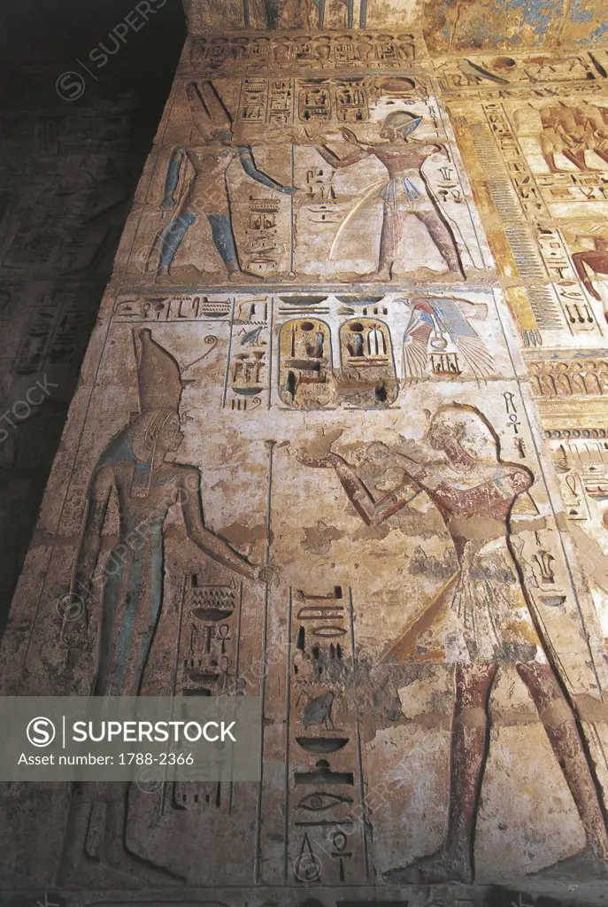 Egypt - Idfu (Edfu). Temple of Horus. Painted reliefs of Ramses II making offerings to Mut and Amon. Ptolemaic dynasty