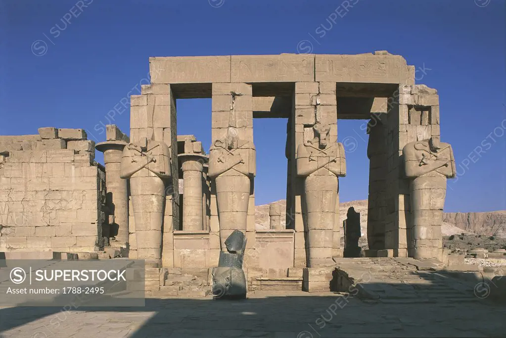 Egypt - Ancient Thebes (UNESCO World Heritage List, 1979). Valley of the Kings. Funerary temple of Ramses II 'Ramesseum'. Figures of Osiris at inner court pillars