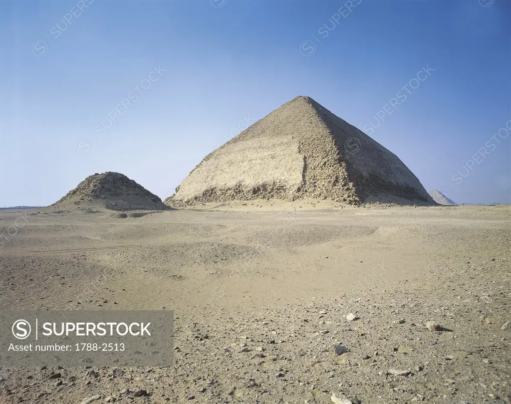 Egypt - Cairo - Ancient Memphis (UNESCO World Heritage List, 1979). Dahshur. Blunted Pyramid of Snefru, 4th Dynasty, and satellite pyramid on its southern side. Red Pyramid in the background