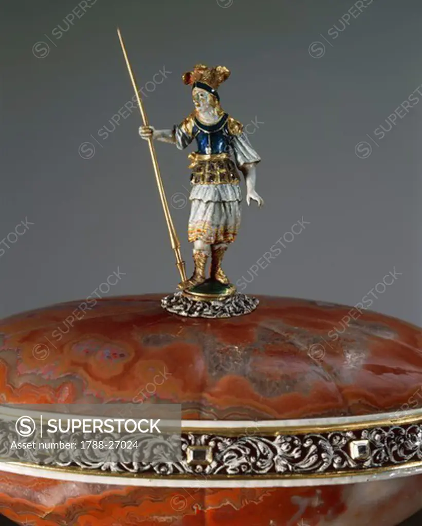 Goldsmith's art, Germany, 17th century. Carved agate vase with lid and enamelled silver-gilt mount set with diamonds, height cm. 21. Detail: on top lid, statuette of a soldier.