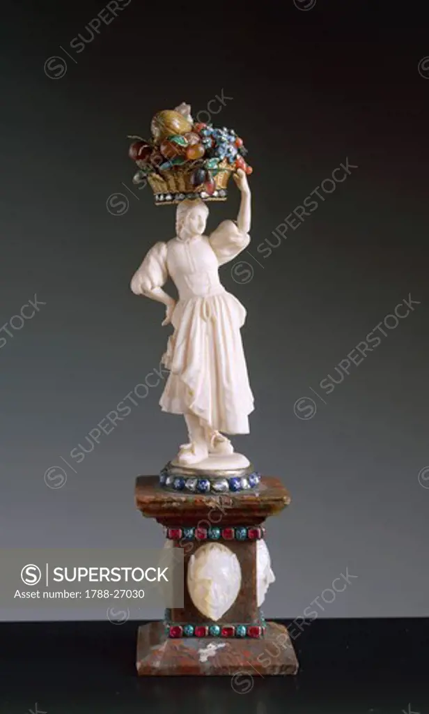 Goldsmith's art, Germany, 18th century. Figurine of fruit woman seller in ivory, enamelled gold, diamonds, pietre dure, with agate base decorated with rubies and pearls.
