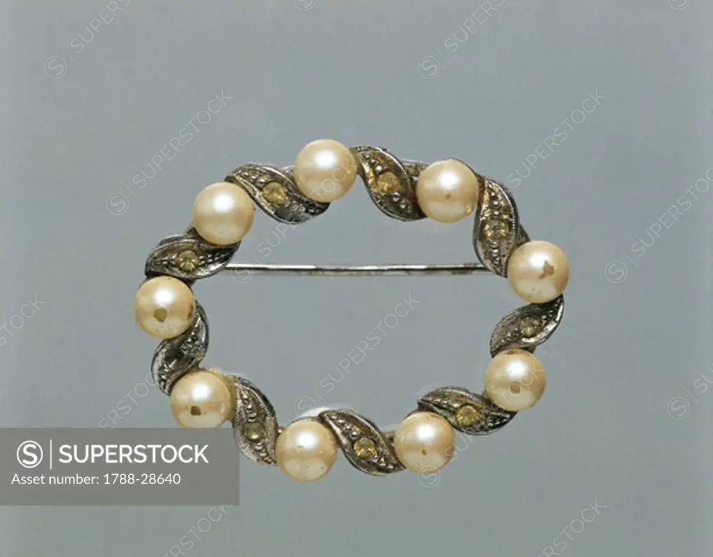 Silversmith's art, Italy, 20th century. Oval torchon silver brooch set with pearls, 1960s.