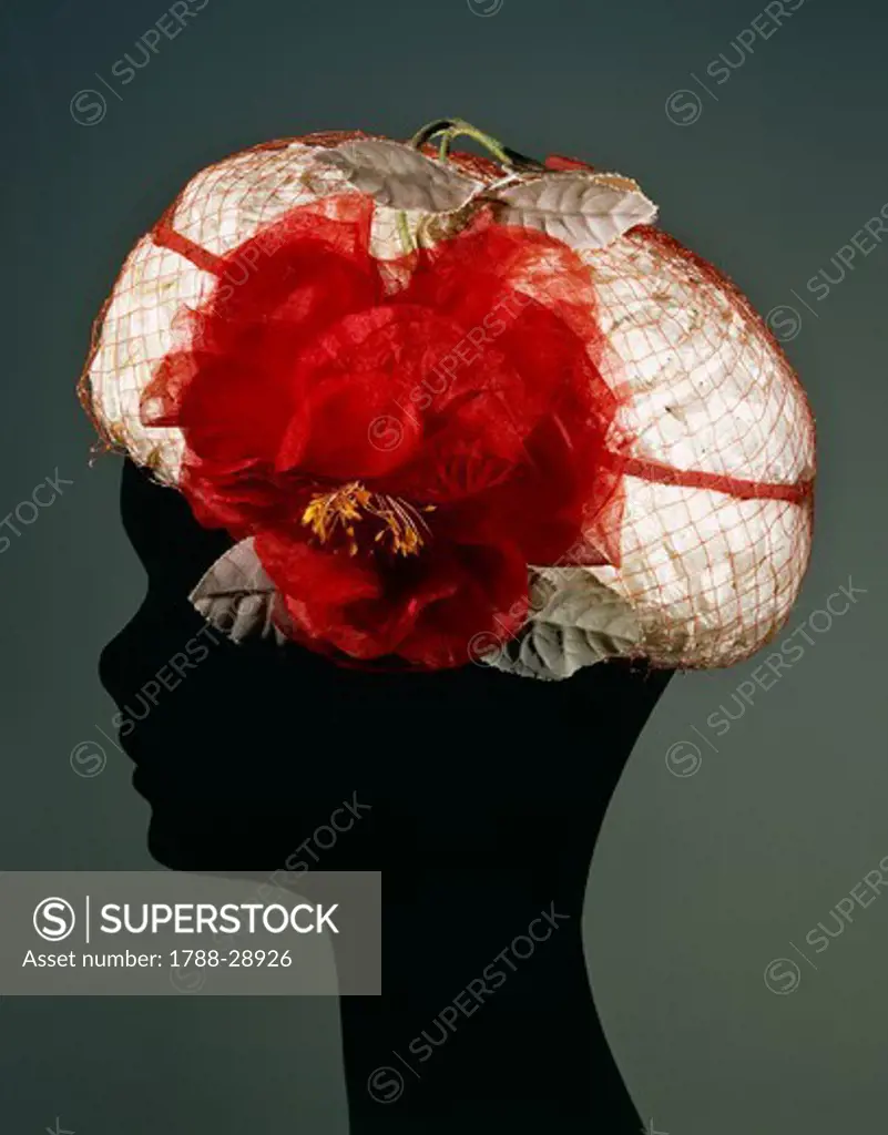 Fashion, 20th century. Women's white cellophane hat with veil, ornamented with chiffon flower and print velvet leaves, around 1950.