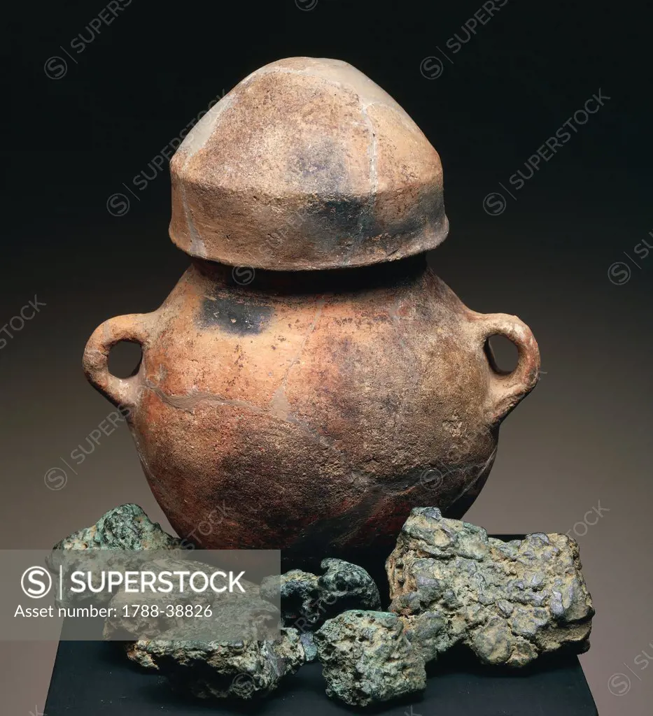 Nuragic civilization. Small ceramic olla with bronze fragments. From Sardinia Region.