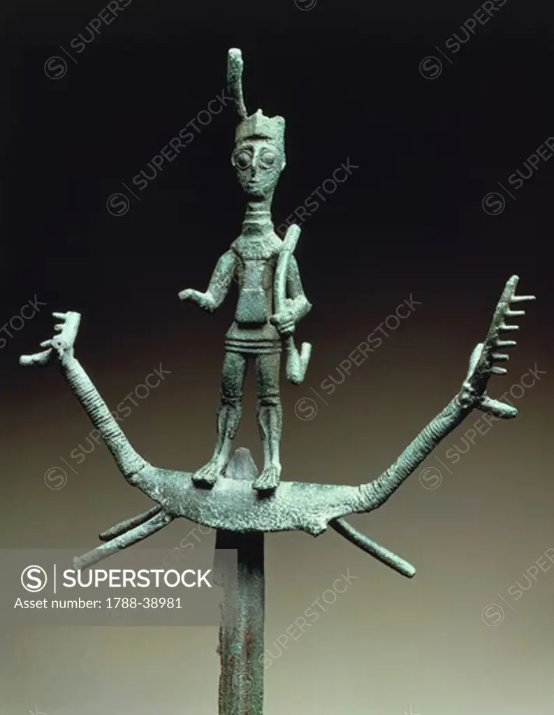 Nuragic civilization, 8th century b.C. Bronze votive sword hilt in shape of an archer standing on a stag. From Sardinia Region.