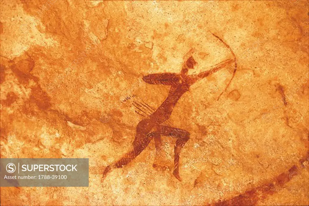 Algeria - Sahara desert - Tassili-n-Ajjer National Park (UNESCO World Heritage List, 1982). Rock carving depicting a man with bow and arrows.